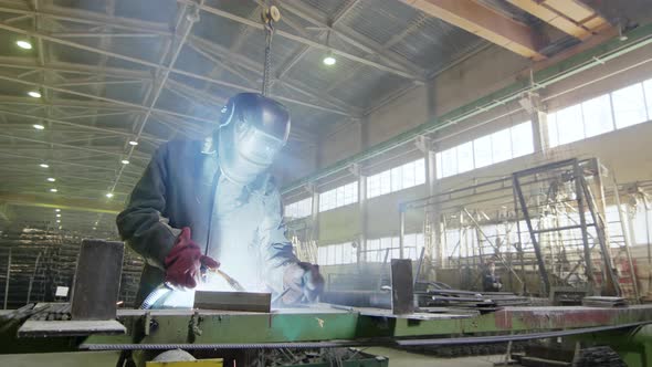 Worker welding at factory