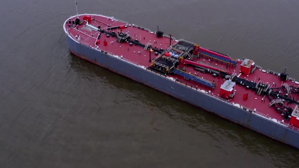 Aerial backward tilt-up reveal of barge on Hudson river, USA alt
