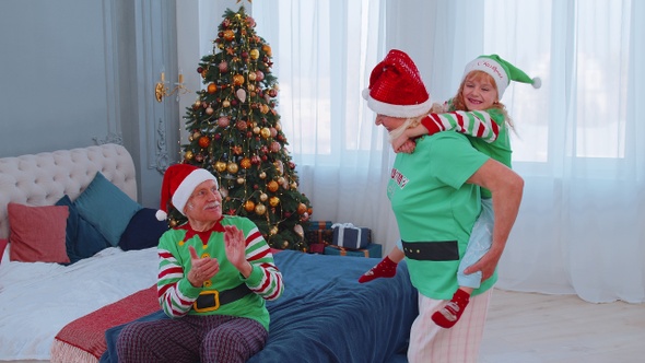 Grandmother Carrying Small Girl Toddler Kid Playing Piggyback Ride Game at Home Christmas Bedroom alt