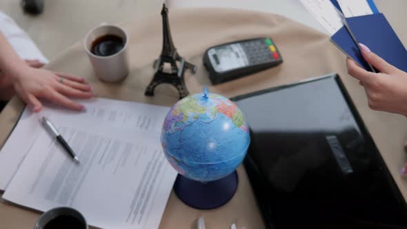 Closeup of a Girl Travel Agent Gives Passports with Plane Tickets to a Couple alt