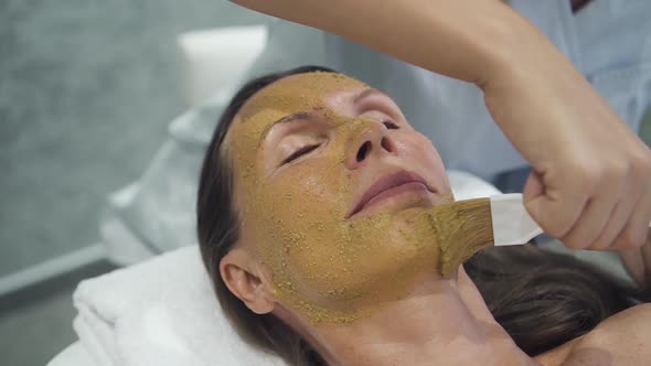 Woman Lying in Spa with Mask on Her Face alt
