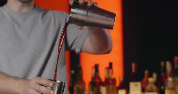 Bartender Superfuses Mixed Drink From One Part of Shaker to Another in Slow Motion Barman Mixes alt