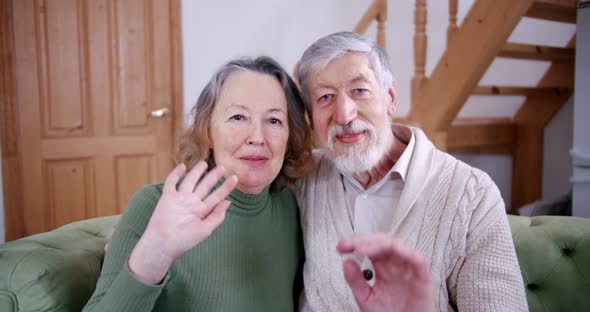 a Portrait Senior Couple Husband and Wife Look Into the Camera and Say Hello on the Video Call