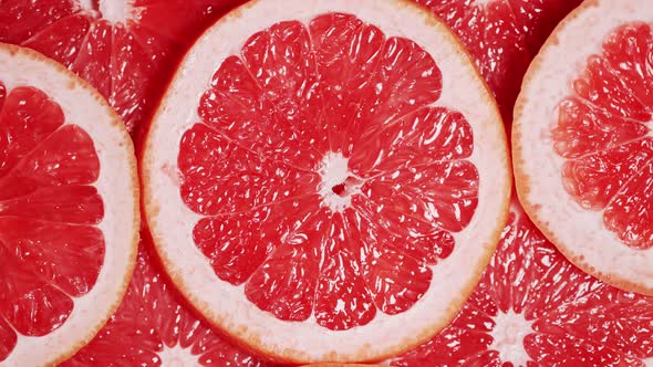 Slow Motion of Rotation Ripe Sliced Grapefruites alt