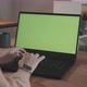 Girl in a Modern Office Working on a Laptop with Green Screen - VideoHive Item for Sale