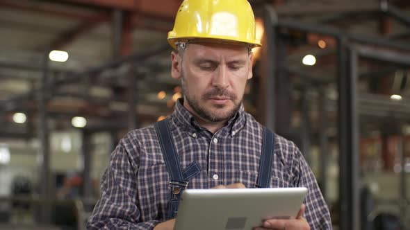 Engineer Filling Out Checklist on Tablet alt