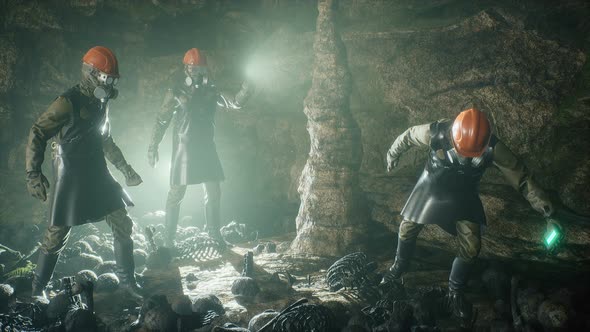 People In Protective Suits In A Cave alt