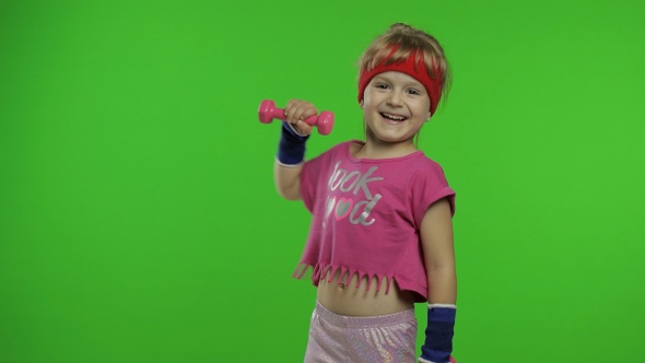 Caucasian Girl in Sportswear Making Exercises with Dumbbells. Workout for Kids. Athletic Child alt