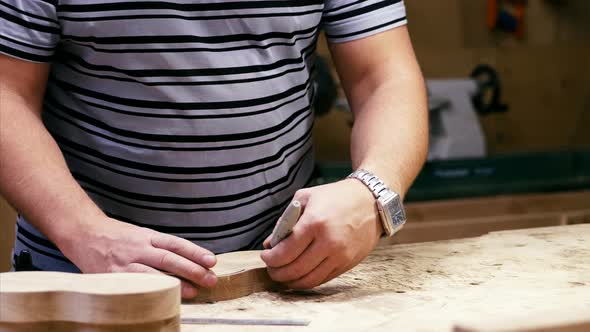 Male Carpenter Marking Figure Lines for Milling on a Wooden Detail
