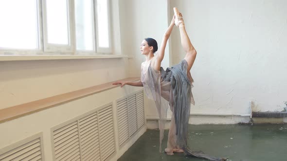 Ballerina Bends Back, Standing on One Leg Doing Stretching, Lifting Leg Up High.