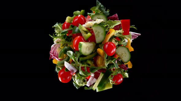 Super Slow Motion Shot of Rotating Exploded Salad Mix on Black at 1000Fps alt