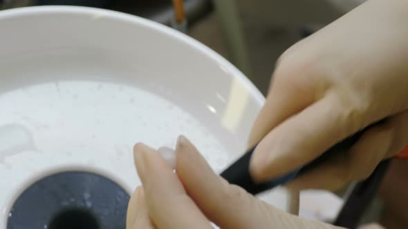 Dentist Treats Veneer Before Installation. Cleaning, Drying. Assistant Purges with Air Dental alt