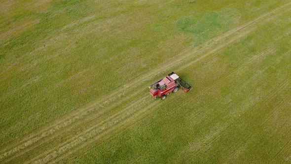 Tractor Harvesting Crop In Autumn, Aerial view