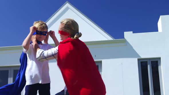 Smiling mother and son pretending to be superhero 4k alt