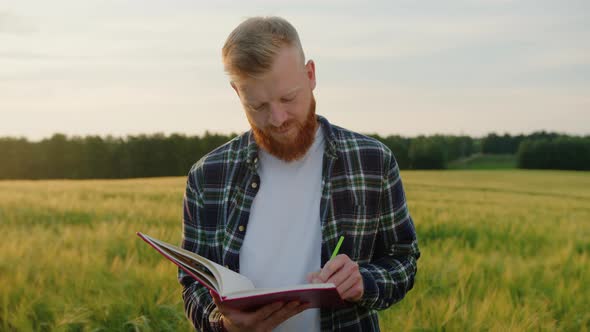 Porter of a Farmer Who Writes Down the Costs of Growing a Crop in a Notebook alt