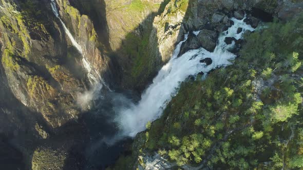 Voringfossen Waterfall and Cliffs with Green Trees in Norway at Sunny Summer Day alt
