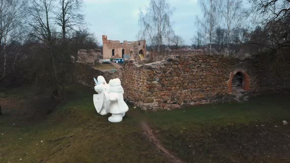 Medieval Castle the Town of Dobele on the West Bank of the River Berze in Winter. Aerial 4K Video alt