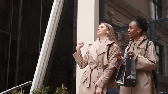 Beautiful Girls Holding Shopping Bags Going Out of the Mall alt