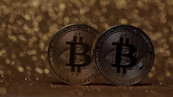 Close Up on gold background with bokeh. Bitcoin BTC coin. New virtual currency. alt