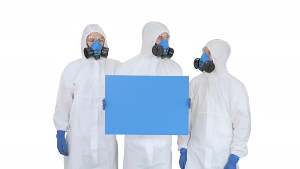 Three Doctors in Protective Suits Holding Blank Board on White Background alt