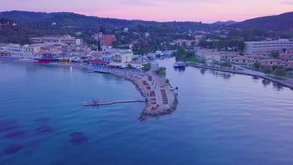 Greece, Corfu Island, drone footage of a beautiful sunset over Messonghi Beach.  Backwards Rise. alt