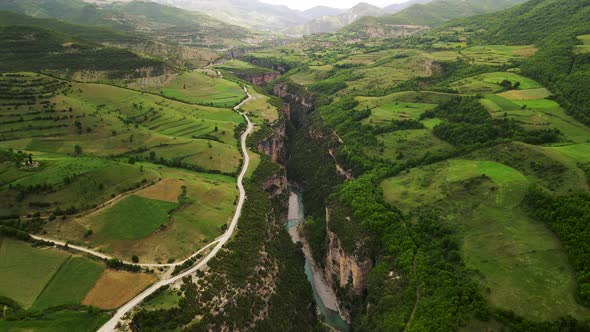 Aerial scenic drone shot of the Osum Canyon (Kanionet e Osumit) in Albania with a river flowing thro alt