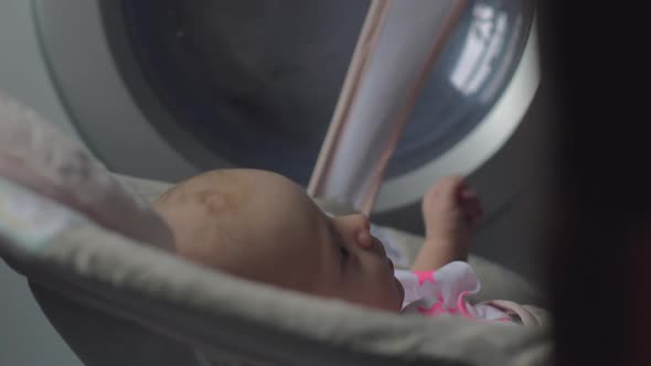 Two Months Baby Girl in Bouncy Seat at Home alt