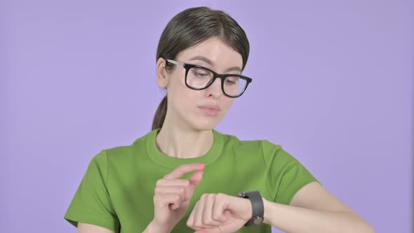 Young Woman Using Smart Watch on  Pink Background alt