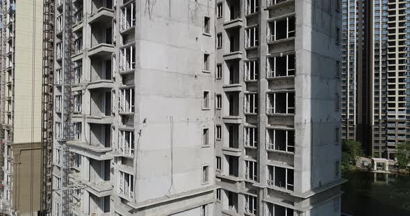 Aerial footage of multistory apartment construction site in China alt