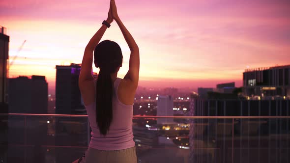 View of Young asian Woman Sitting on Mat and Practicing Yoga and Meditation alt