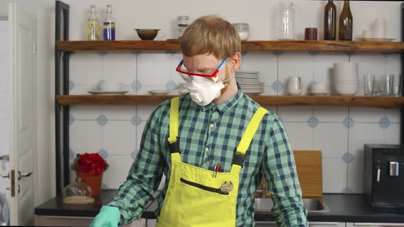 Worker in Mask Came To Install New Furniture in Modern Kitchen alt