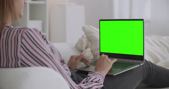 Student Woman Is Chatting Online By Laptop with Green Screen for Chroma Key Technology, Resting at alt