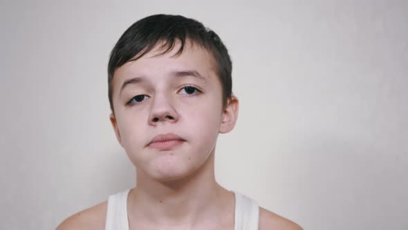 Handsome Caucasian Boy Chewing Gum Looking at Camera alt