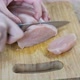 Slicing chicken fillet.
