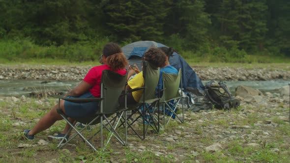 Relaxed Diverse Multicultural Backpackers Enjoying Scenic Mountain Nature on Trek alt