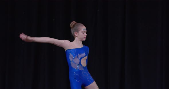 Two Little Girls are Doing Gymnastics at a Competition on Stage Handstand alt