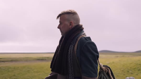 Portrait of a Stylish Blond Man with a Scarf On Gets In the Little Black House alt