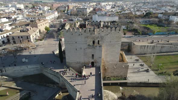 Aerial pullback view of Torre De Calahorra, Cordoba, Spain. Tower at end of Roman Bridge of Córdoba