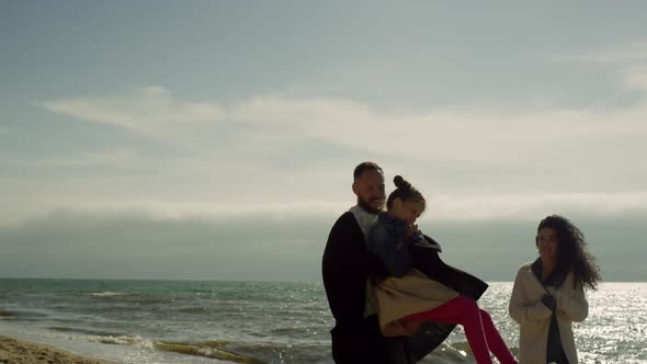 Positive Family Enjoying Beach Sunny Day at Seashore alt