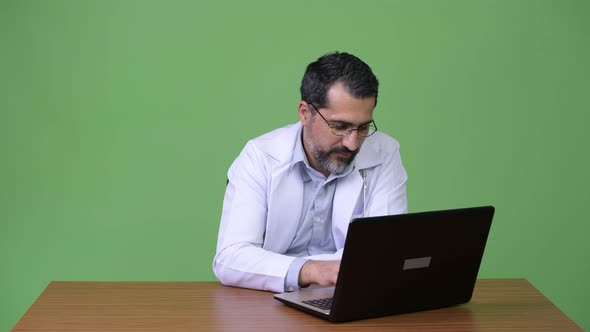 Handsome Persian Bearded Man Doctor Using Laptop