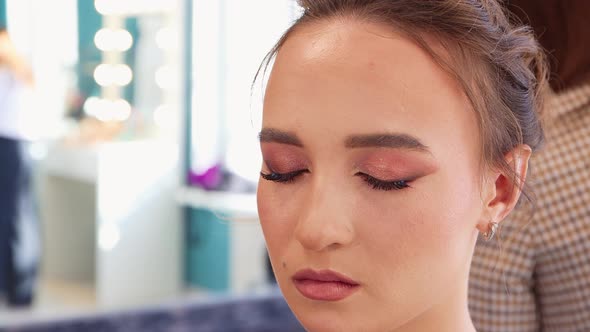 The Hand of the Master Glues the Eyelashes to the Eyelid Closeup alt