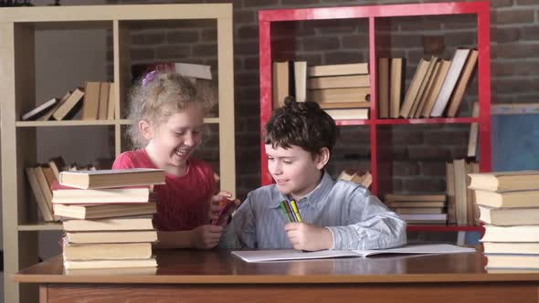 Children's creativity. Children draw in room. boy and a girl draw pictures. alt