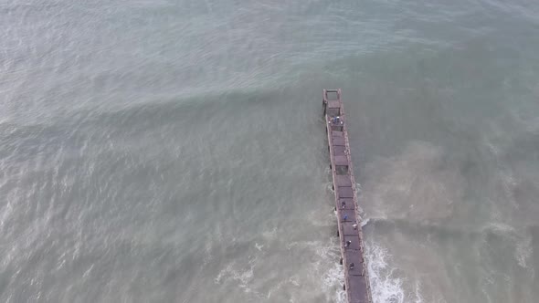 Drone Rising and Showing Landscape of Pier with Waves