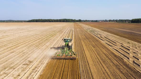 Tractor with Disc Harrow on an Agricultural Field alt