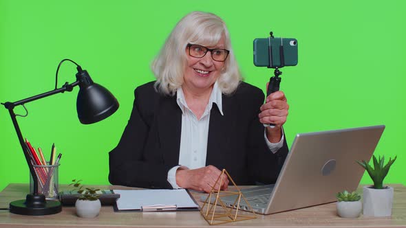 Senior Businesswoman Making Mobile Phone Conference Video Consultation Call Center Agent Operator alt