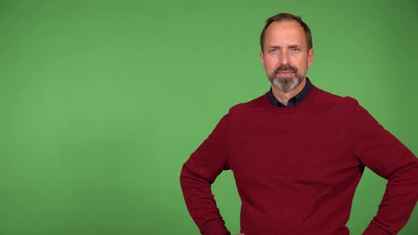 A Middleaged Handsome Caucasian Man Smiles at the Camera  Green Screen Background