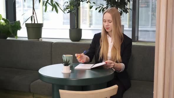 Young Blond Woman is Working in Cafe Restaurant