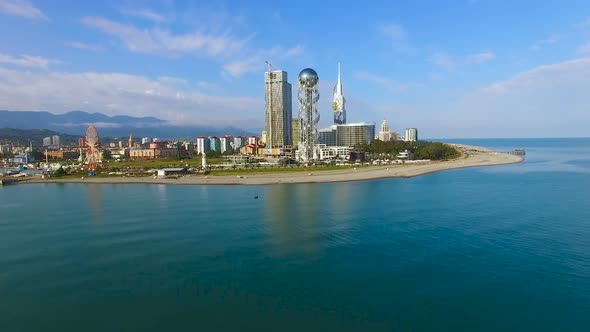 Batumi Seafront Park with Alphabetic Tower Against Cityscape, Aerial Zooming In alt
