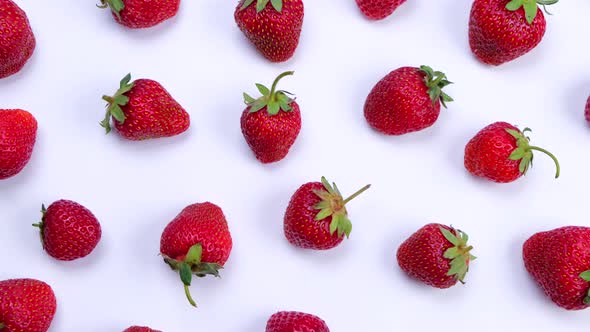 Rotating Ripe Strawberries on a White Background Trendy Bright Summer Background