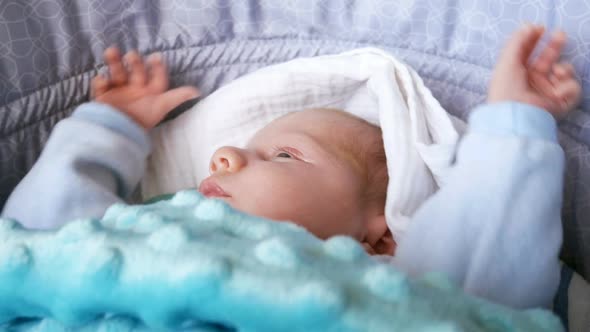 Newborn Baby Waking Up In The Crib Close Up